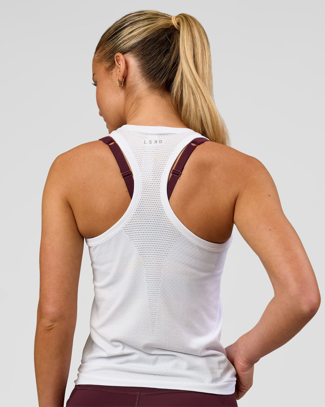 Woman wearing AeroFLX+ Seamless Tank - White/White | Model:Issy | Size:XS - view 4