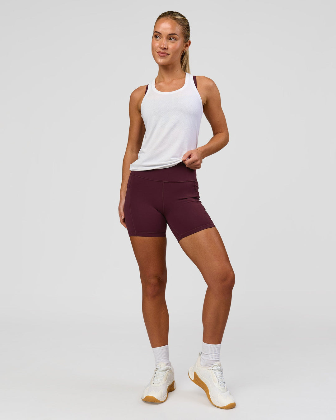 Woman wearing AeroFLX+ Seamless Tank - White/White | Model:Issy | Size:XS - view 5