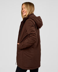 Woman wearing Auxiliary 2.0 Longline Jacket - Hot Chocolate | Model:Issy | Size:XS | Thumbnail Index: 2