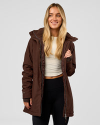 Woman wearing Auxiliary 2.0 Longline Jacket - Hot Chocolate | Model:Issy | Size:XS | Thumbnail Index: 0