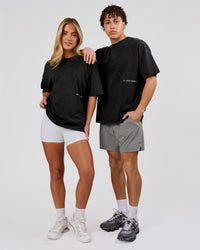 Woman wearing Backline Washed Heavyweight Oversized Tee - Black Washed | Model:Issy | Size:XS | Thumbnail Index: 12