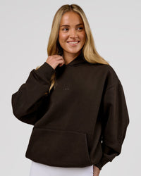 Woman wearing Base Oversized Hoodie - Ground Coffee | Model:Issy | Size:XS | Thumbnail Index: 9
