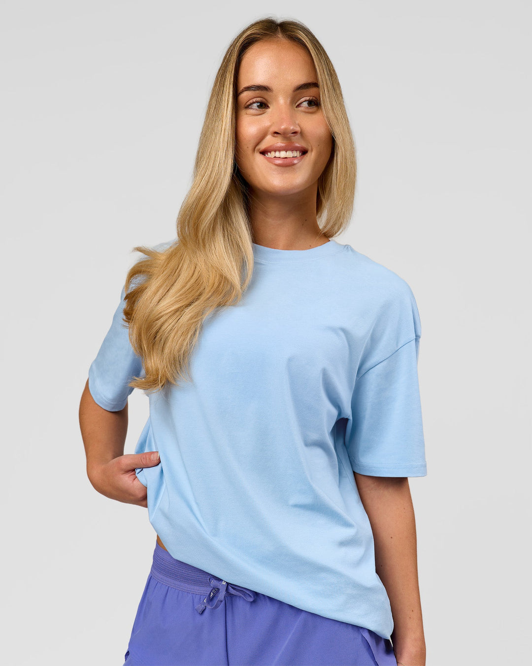 Woman wearing Benchmark FLXCotton Oversized Tee - Open Air-Blue Bell | Model:Issy | Size:XS