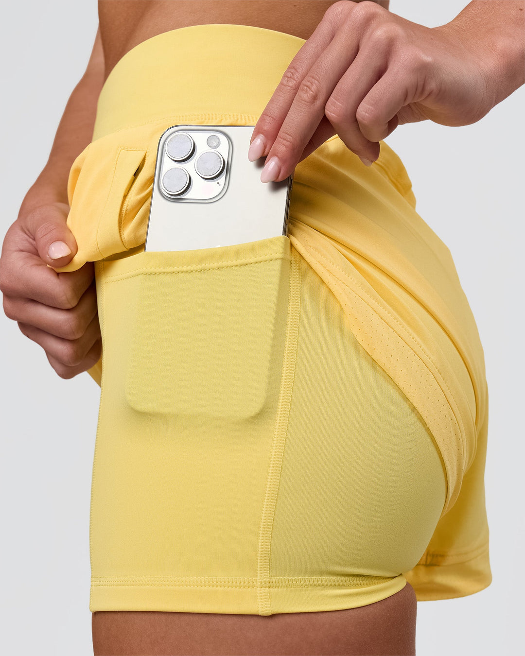 Woman wearing Challenger 3" Lined Performance Short - Lemon | Model:Issy | Size:XS - view 2
