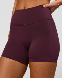 Woman wearing Fusion High-Rise 4" Short Pockets - Cherry Lacquer | Model:Issy | Size:XS | Thumbnail Index: 0