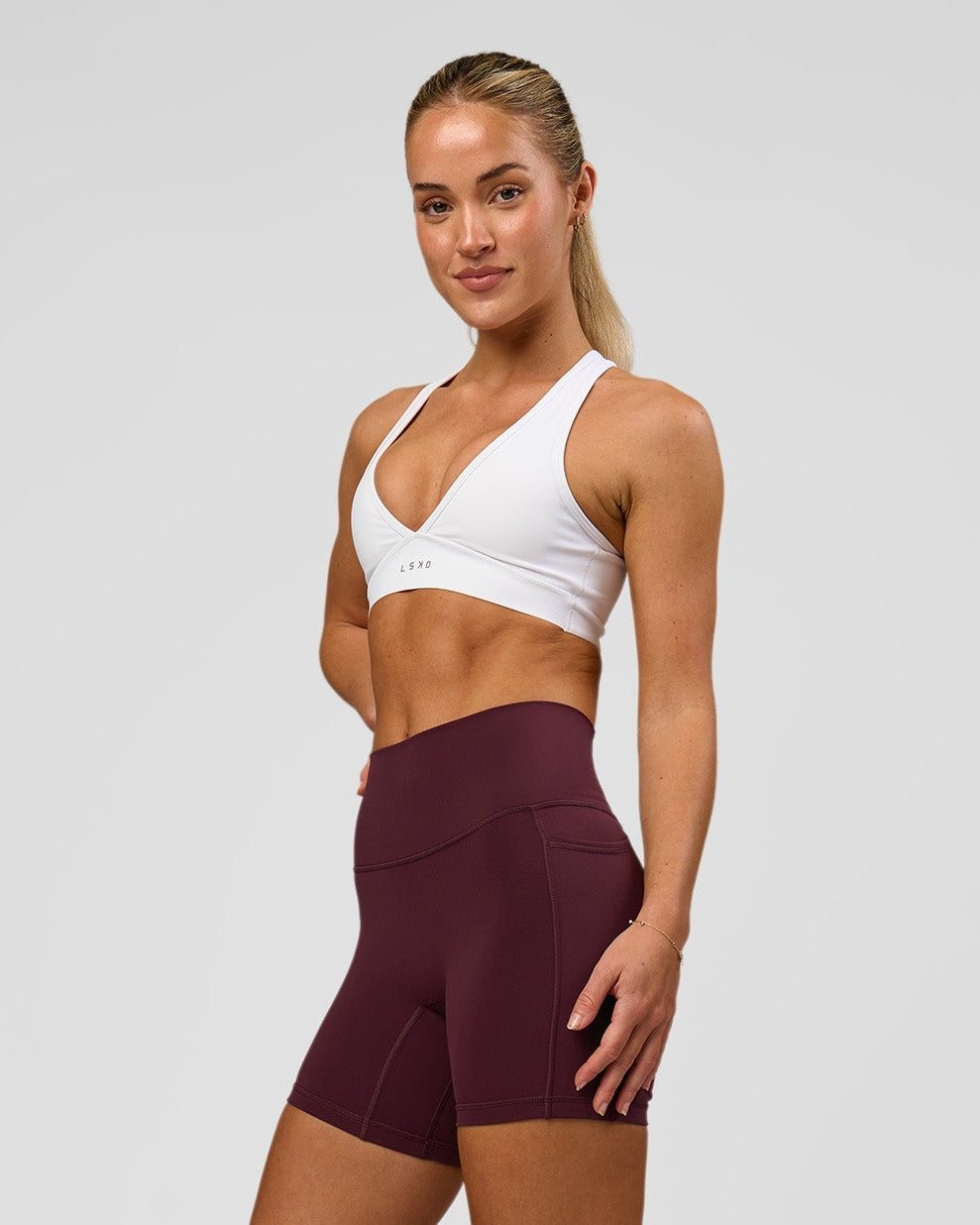 Woman wearing Fusion High-Rise 6" Short Pockets - Cherry Lacquer | Model:Issy | Size:XS - view 1