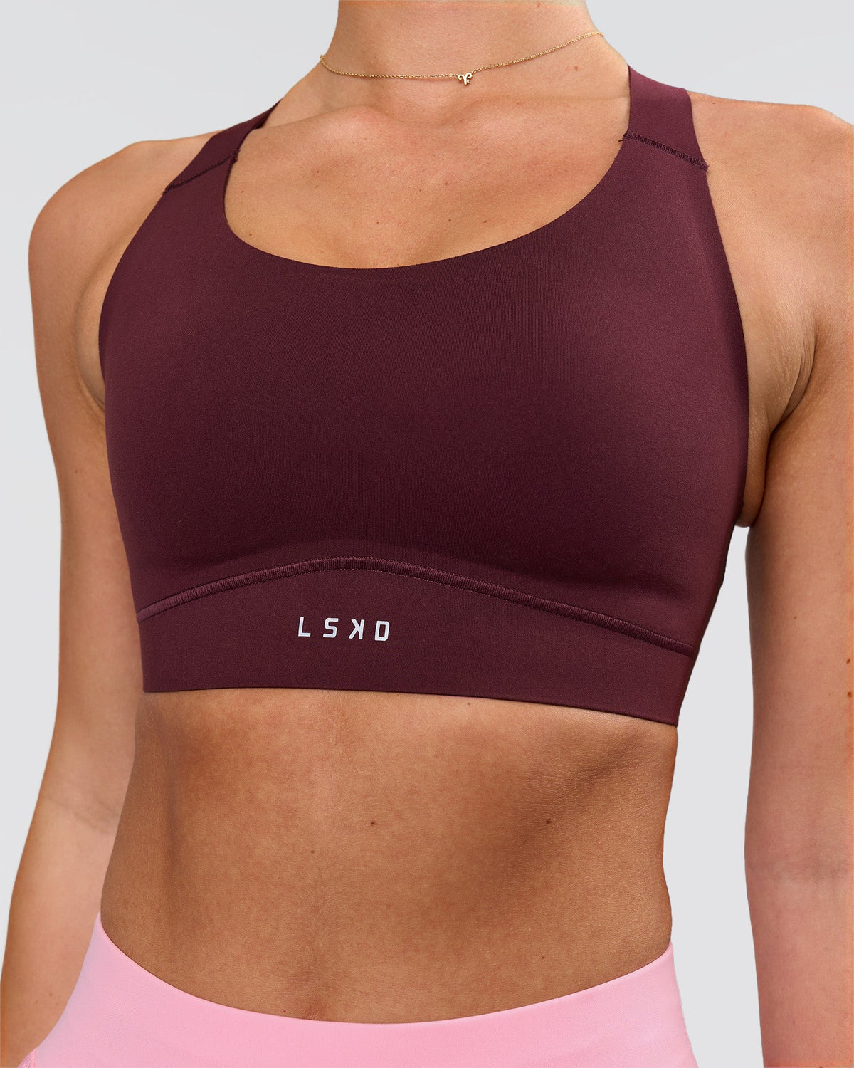 Woman wearing Fusion Sports Bra 2.0 - Cherry Lacquer | Model:Issy | Size:XS