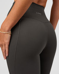 Woman wearing Fusion Ultra High-Rise 7/8 Legging Pockets - Onyx | Model:Issy | Size:XS | Thumbnail Index: 3