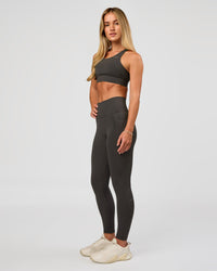 Woman wearing Fusion Ultra High-Rise 7/8 Legging Pockets - Onyx | Model:Issy | Size:XS | Thumbnail Index: 5
