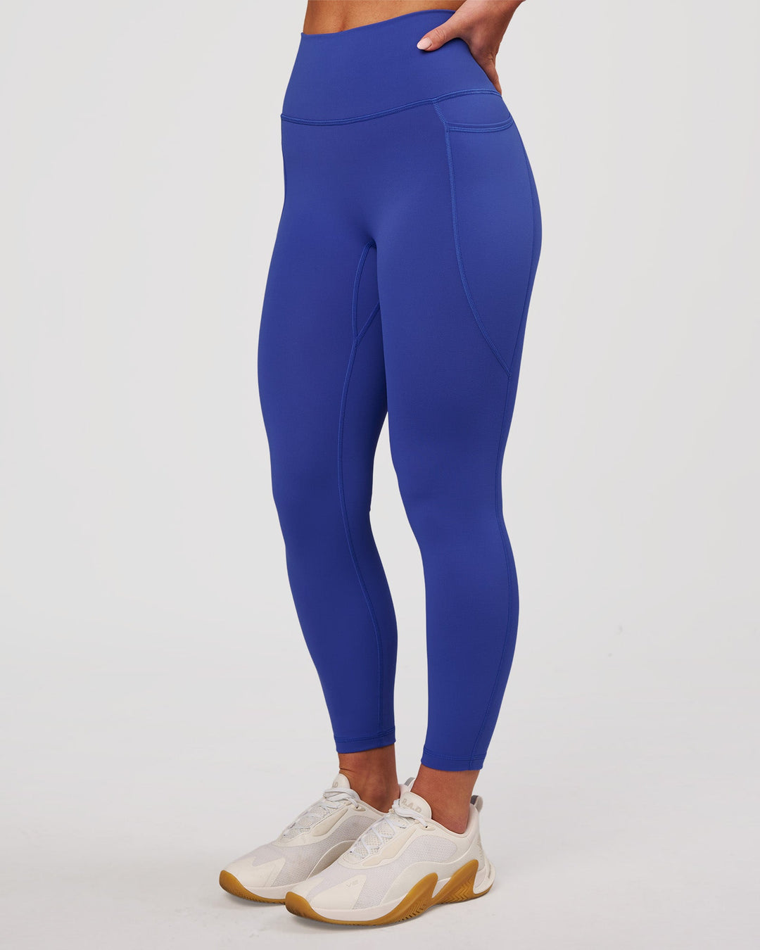 Woman wearing Fusion V-Contour Ultra High-Rise 7/8 Legging Pockets - Power Cobalt | Model:Issy | Size:XS - view 1