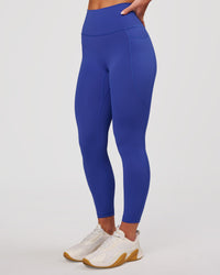 Woman wearing Fusion V-Contour Ultra High-Rise 7/8 Legging Pockets - Power Cobalt | Model:Issy | Size:XS | Thumbnail Index: 0