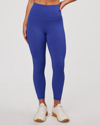 Woman wearing Fusion V-Contour Ultra High-Rise 7/8 Legging Pockets - Power Cobalt | Model:Issy | Size:XS | Thumbnail Index: 1
