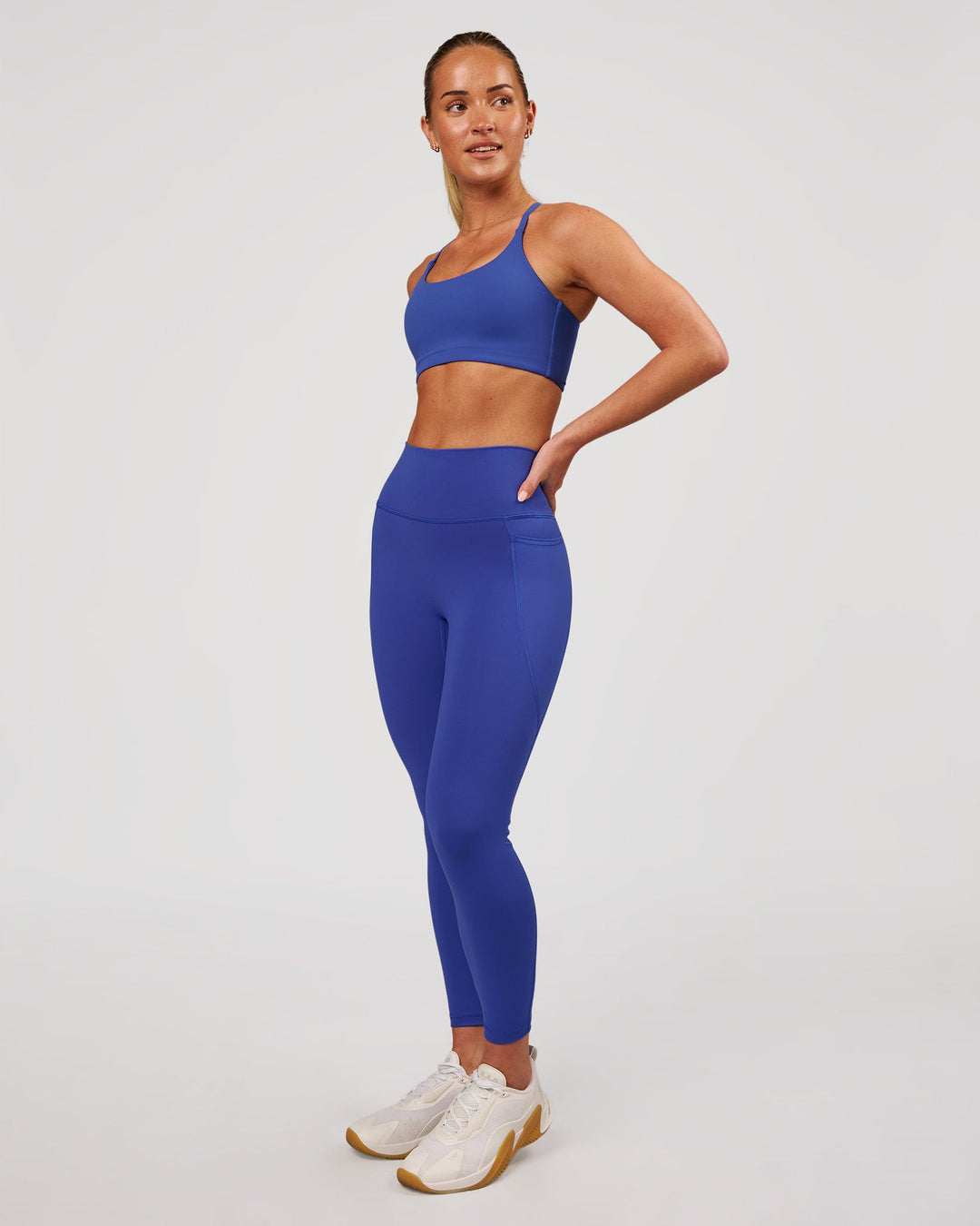 Woman wearing Fusion V-Contour Ultra High-Rise 7/8 Legging Pockets - Power Cobalt | Model:Issy | Size:XS - view 7
