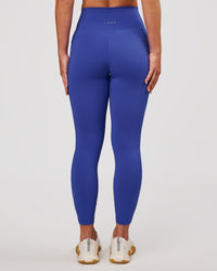 Woman wearing Fusion V-Contour Ultra High-Rise 7/8 Legging Pockets - Power Cobalt | Model:Issy | Size:XS | Thumbnail Index: 0
