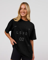 Woman wearing Game Plan Heavyweight FLXCotton Oversized Tee - Black | Model:Issy | Size:XS | Thumbnail Index: 2