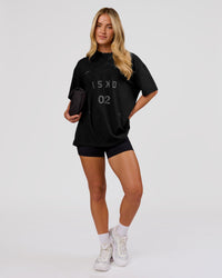 Woman wearing Game Plan Heavyweight FLXCotton Oversized Tee - Black | Model:Issy | Size:XS | Thumbnail Index: 4