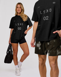 Woman wearing Game Plan Heavyweight FLXCotton Oversized Tee - Black | Model:Issy | Size:XS | Thumbnail Index: 9
