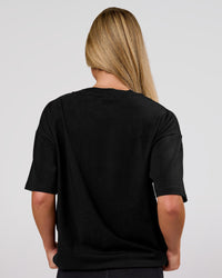 Woman wearing Game Plan Heavyweight FLXCotton Oversized Tee - Black | Model:Issy | Size:XS | Thumbnail Index: 12