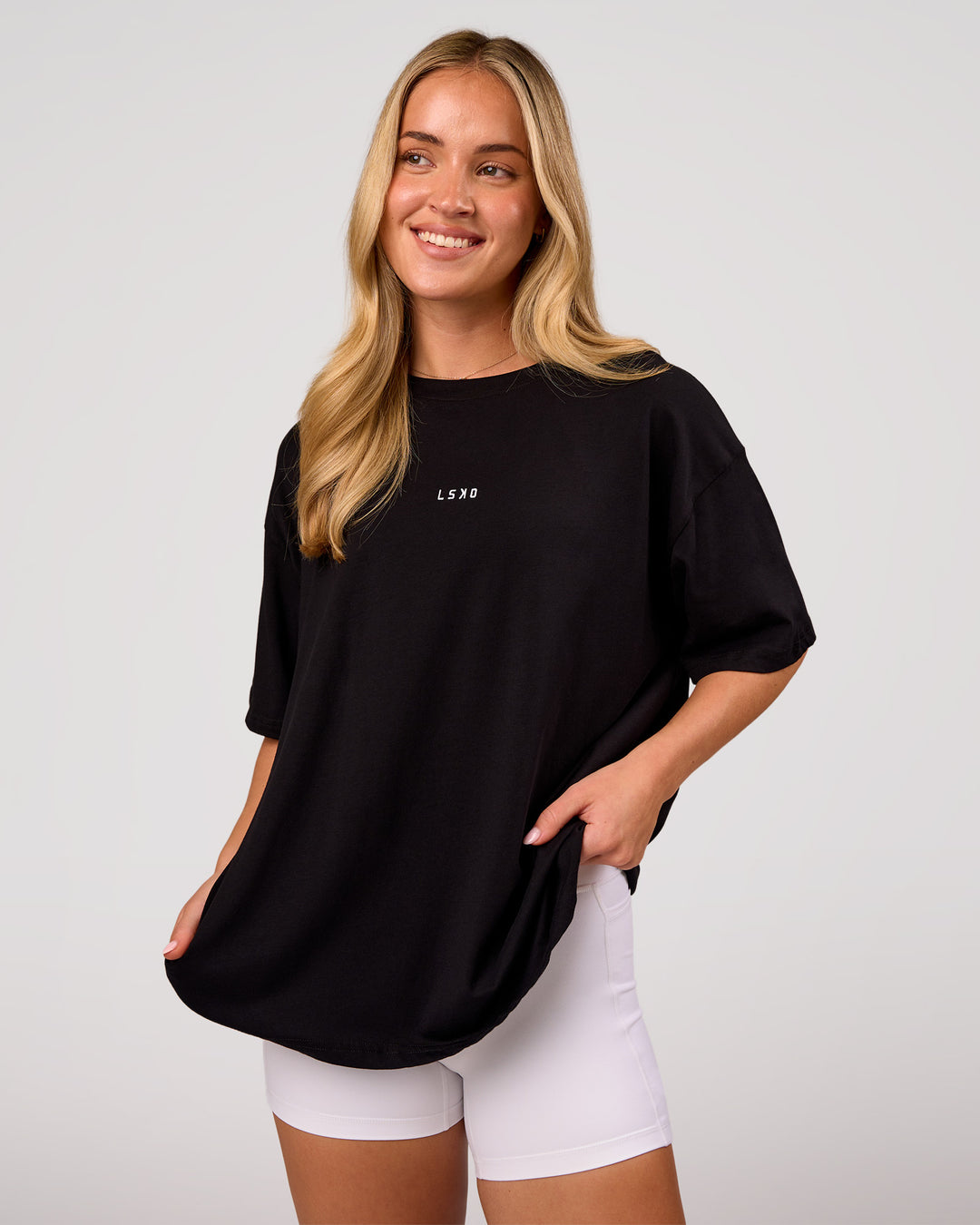 Woman wearing Go-To FLXCotton Oversized Tee - Black-White | Model:Issy | Size:XS - view 1