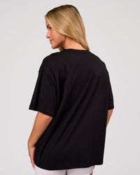 Woman wearing Go-To FLXCotton Oversized Tee - Black-White | Model:Issy | Size:XS | Thumbnail Index: 2