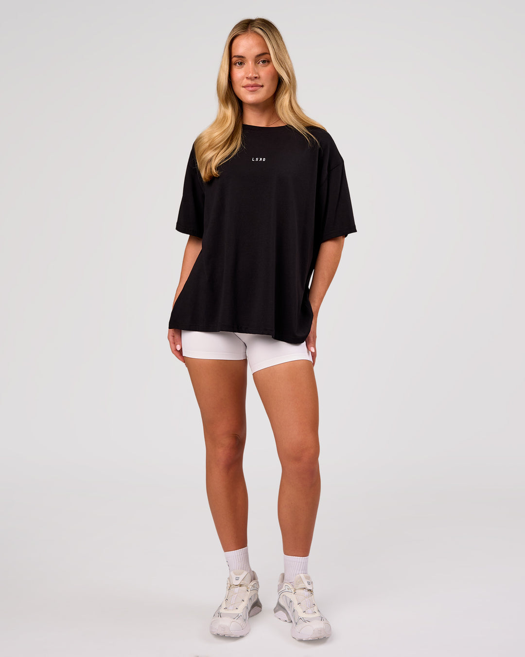 Woman wearing Go-To FLXCotton Oversized Tee - Black-White | Model:Issy | Size:XS - view 4