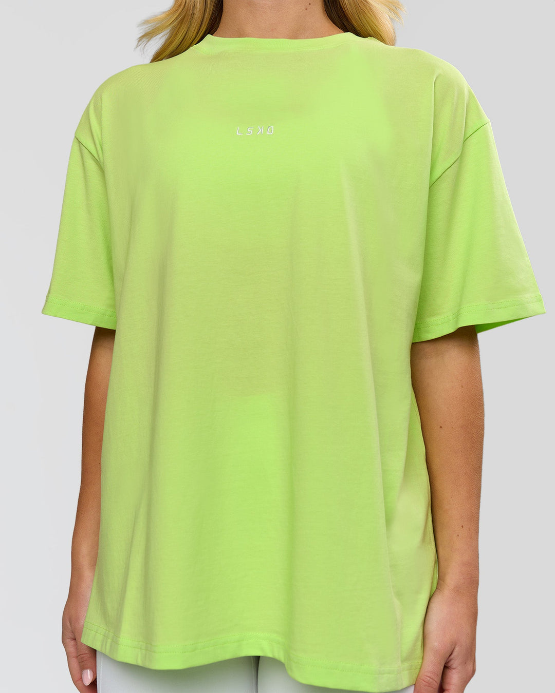 Woman wearing Go-To FLXCotton Oversized Tee - Lime Glo-White | Model:Issy | Size:XS - view 2