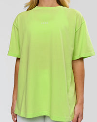 Woman wearing Go-To FLXCotton Oversized Tee - Lime Glo-White | Model:Issy | Size:XS | Thumbnail Index: 1