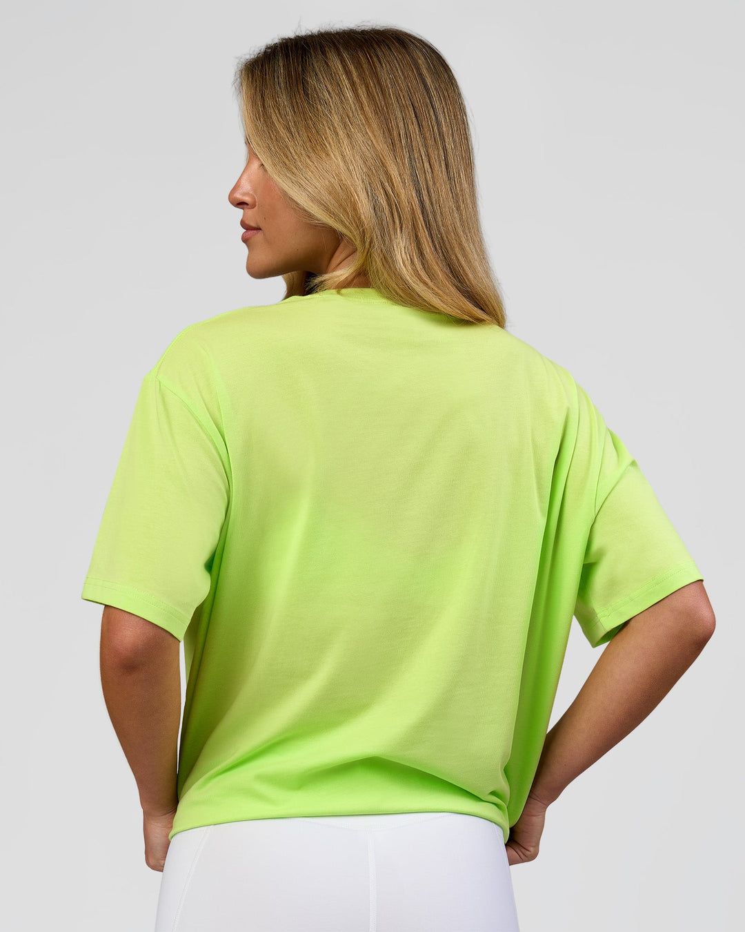 Woman wearing Go-To FLXCotton Oversized Tee - Lime Glo-White | Model:Issy | Size:XS - view 3