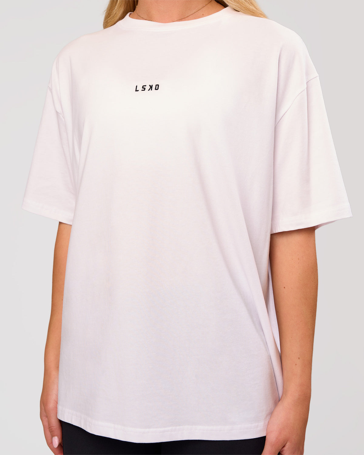 Woman wearing Go-To FLXCotton Oversized Tee - White-Black | Model:Issy | Size:XS - view 2