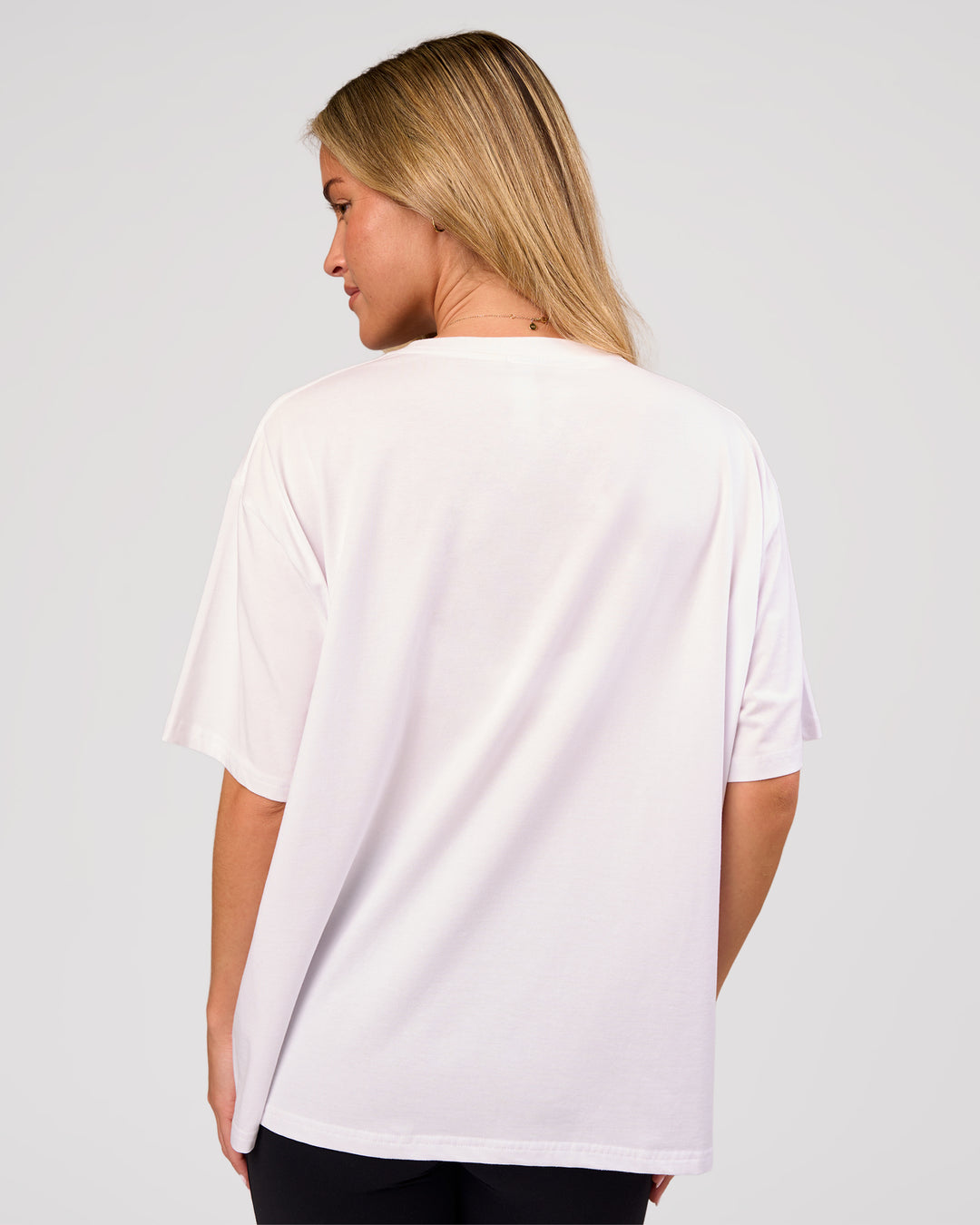 Woman wearing Go-To FLXCotton Oversized Tee - White-Black | Model:Issy | Size:XS - view 3