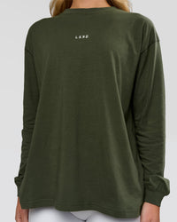 Woman wearing Go-To Long Sleeve FLXCotton Oversized Tee - Pure Olive-White | Model:Issy | Size:XS | Thumbnail Index: 2
