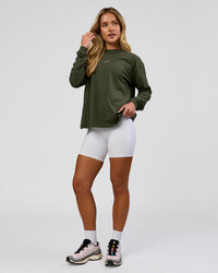 Woman wearing Go-To Long Sleeve FLXCotton Oversized Tee - Pure Olive-White | Model:Issy | Size:XS | Thumbnail Index: 3