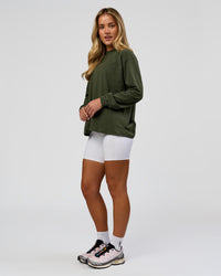 Woman wearing Go-To Long Sleeve FLXCotton Oversized Tee - Pure Olive-White | Model:Issy | Size:XS | Thumbnail Index: 5