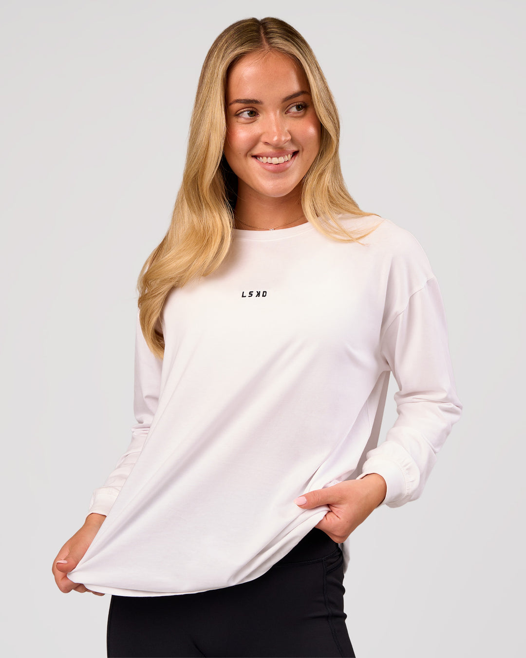 Woman wearing Go-To Long Sleeve FLXCotton Oversized Tee - White-Black | Model:Issy | Size:XS - view 1