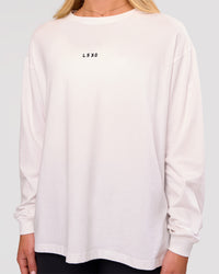 Woman wearing Go-To Long Sleeve FLXCotton Oversized Tee - White-Black | Model:Issy | Size:XS | Thumbnail Index: 2