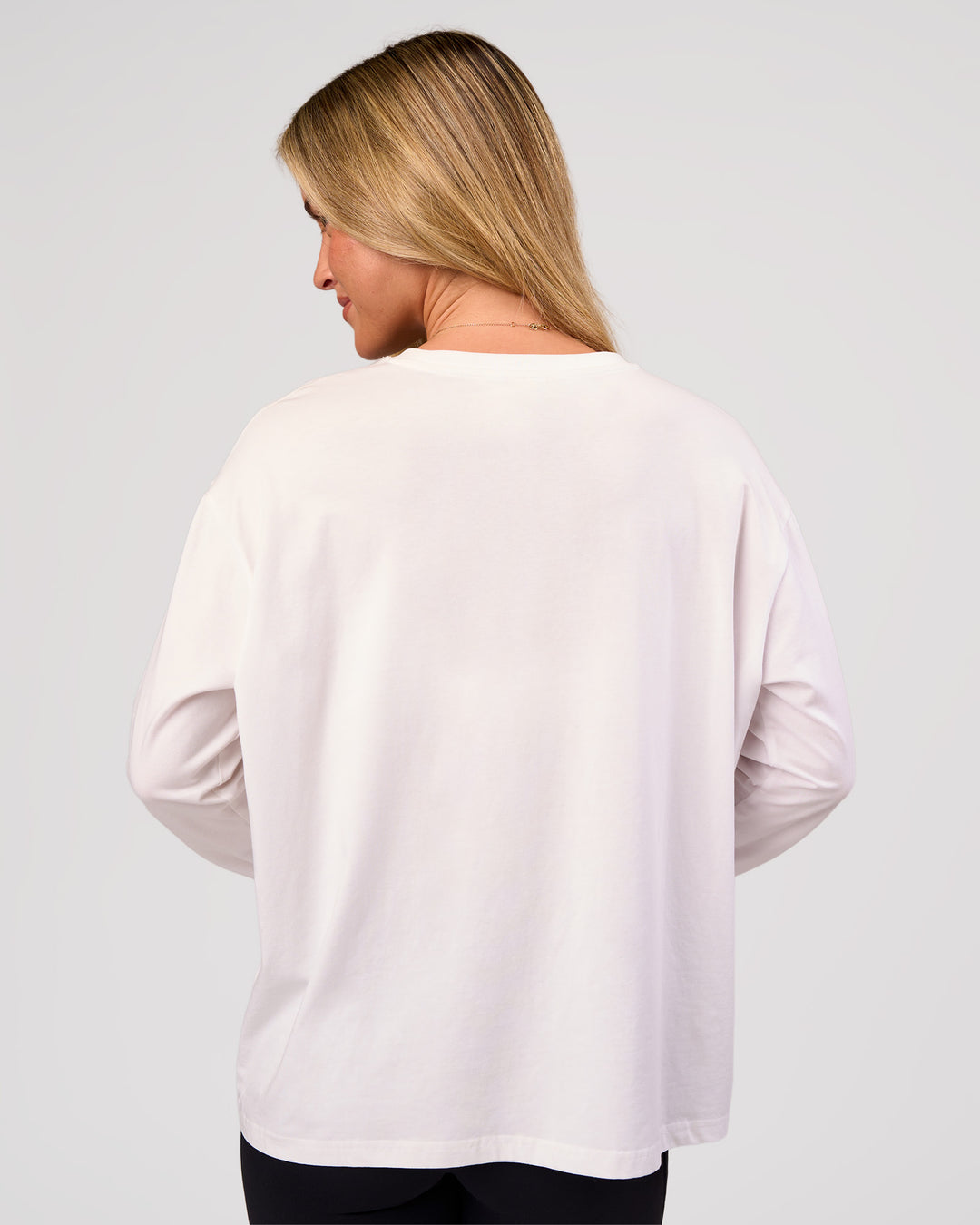 Woman wearing Go-To Long Sleeve FLXCotton Oversized Tee - White-Black | Model:Issy | Size:XS - view 4