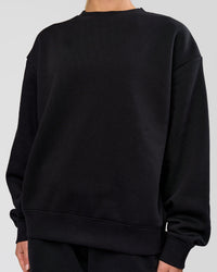 Woman wearing Go-To Oversized Sweater - Black | Model:Issy | Size:XS