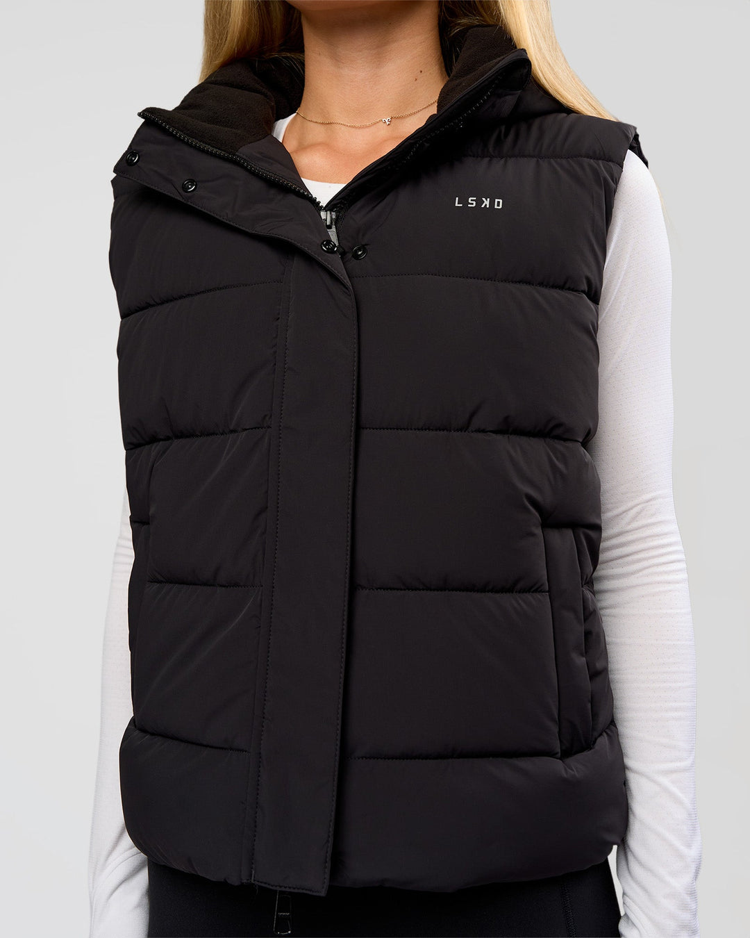 Woman wearing Go-To Puffer Vest - Black | Model:Issy | Size:XS - view 3
