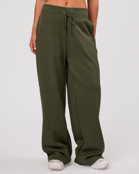 Woman wearing Go-To Wide Leg Track Pant - Pure Olive | Model:Issy | Size:XS | Thumbnail Index: 0