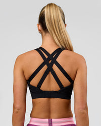 Woman wearing High Velocity Sports Bra - Black | Model:Issy | Size:XS | Thumbnail Index: 1