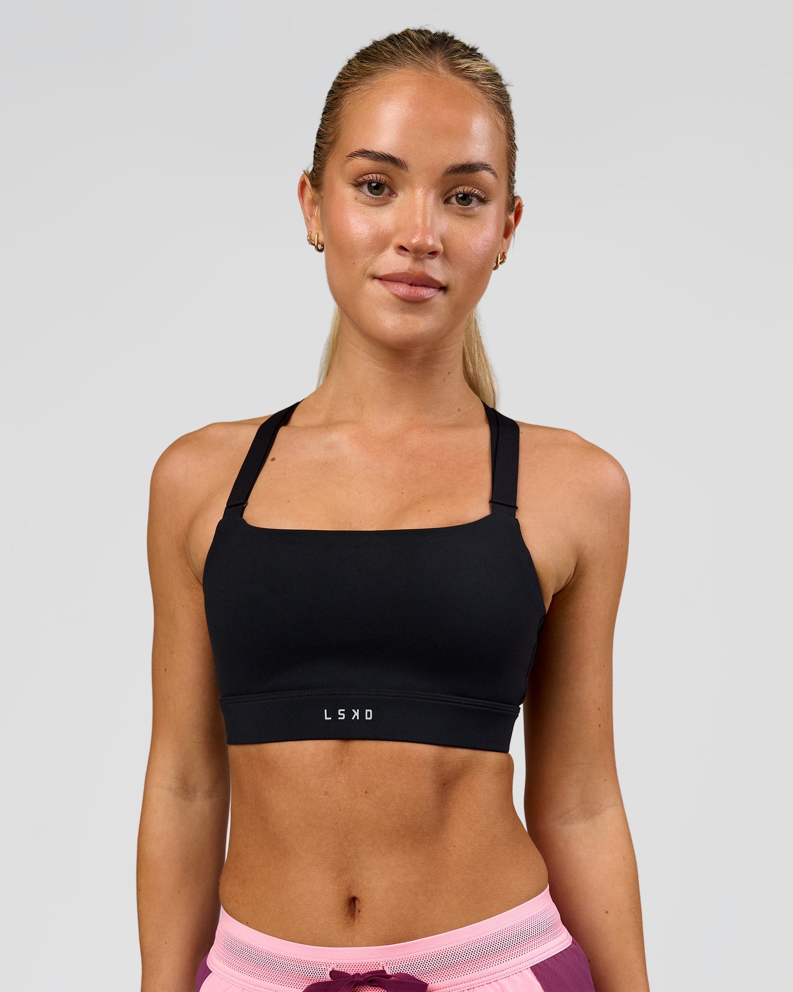 Woman wearing High Velocity Sports Bra - Black | Model:Issy | Size:XS