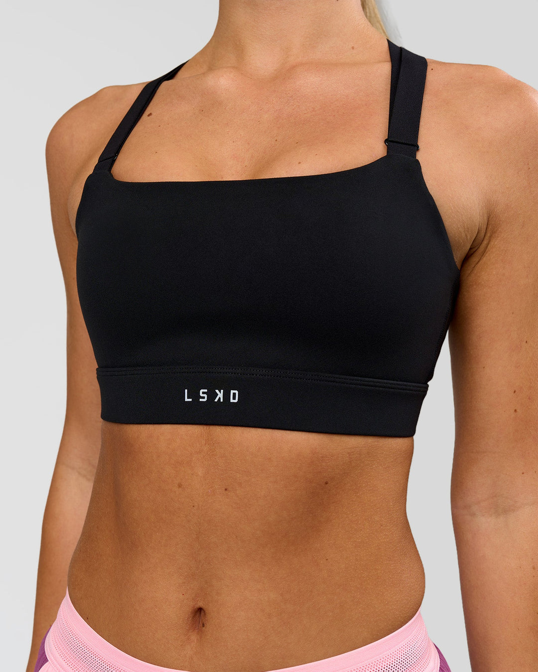 Woman wearing High Velocity Sports Bra - Black | Model:Issy | Size:XS - view 3
