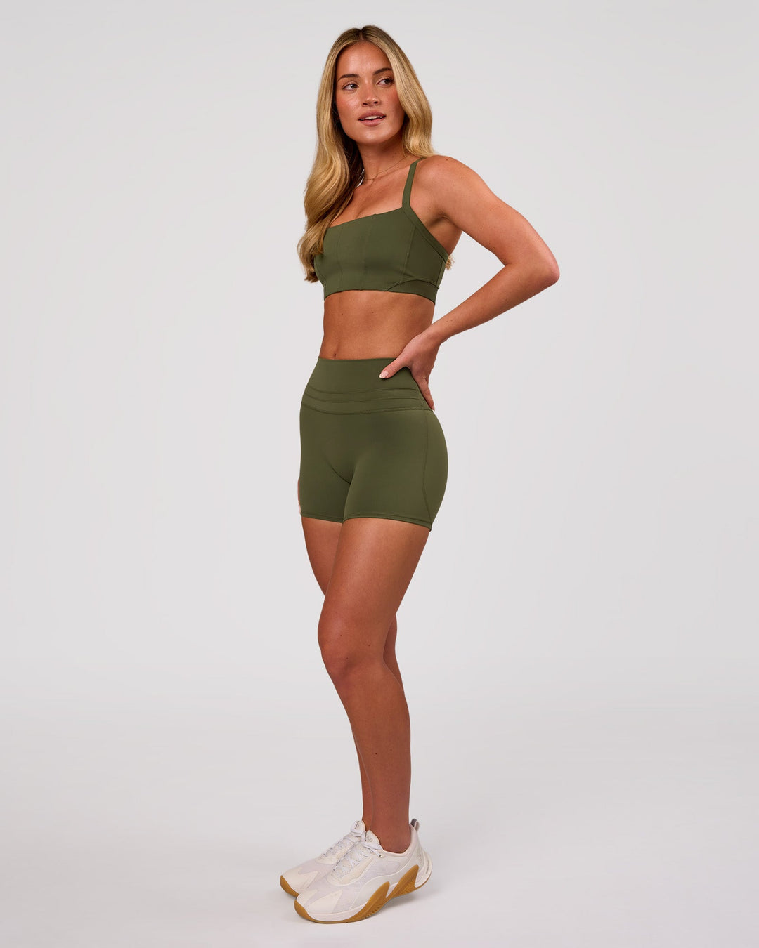 Woman wearing Momentum Corset Sports Bra - Pure Olive | Model:Issy | Size:XS - view 5