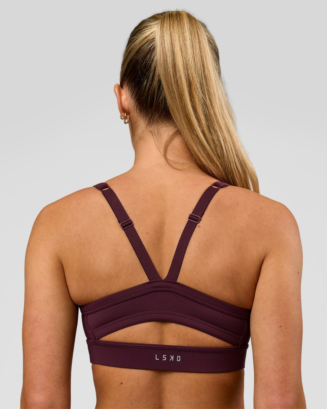 Woman wearing Momentum Sports Bra - Cherry Lacquer | Model:Issy | Size:XS - view 2