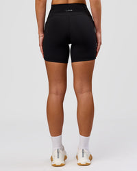 Woman wearing O.G. Fusion Ultra High-Rise 6" Short Pockets - Black | Model:Issy | Size:XS | Thumbnail Index: 10