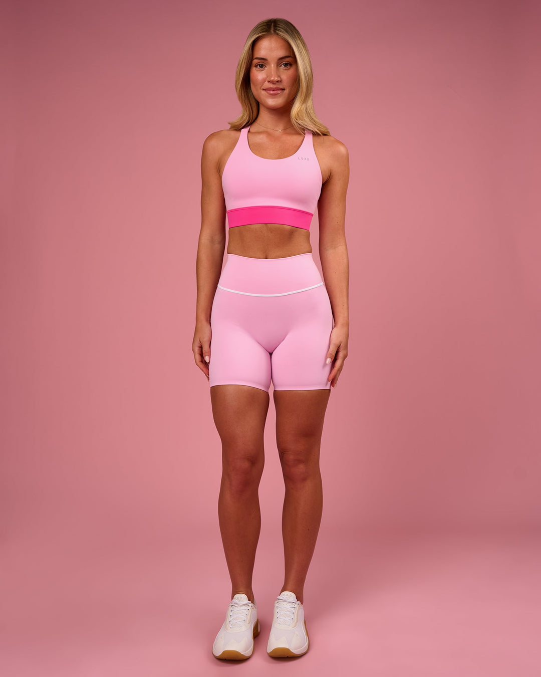 Woman wearing Pinnacle High-Rise 6" Short - Pink Rose-White | Model:Issy | Size:XS - view 3