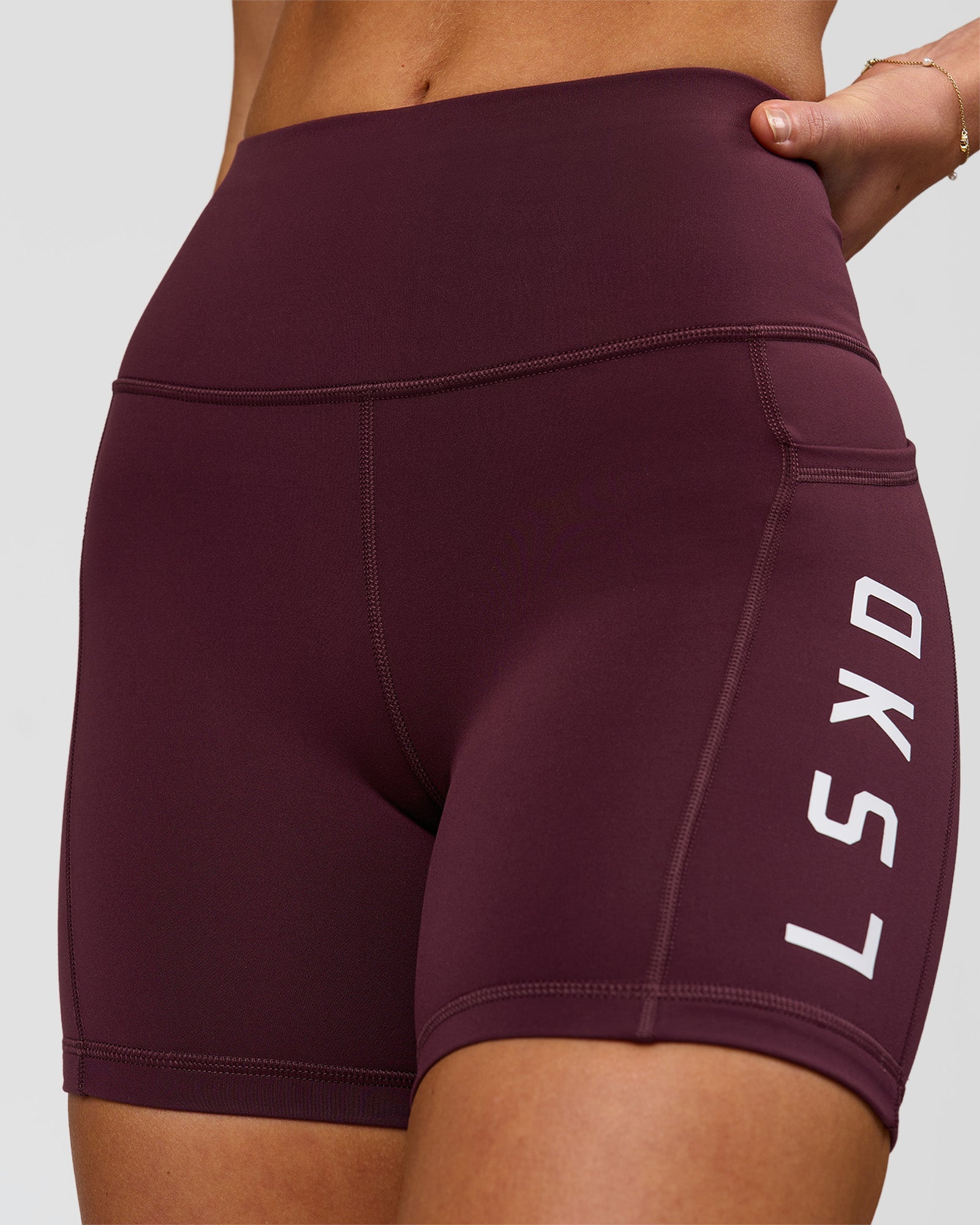 Woman wearing Rep Ultra High-Rise 4" Short Pockets - Cherry Lacquer-White | Model:Issy | Size:XS