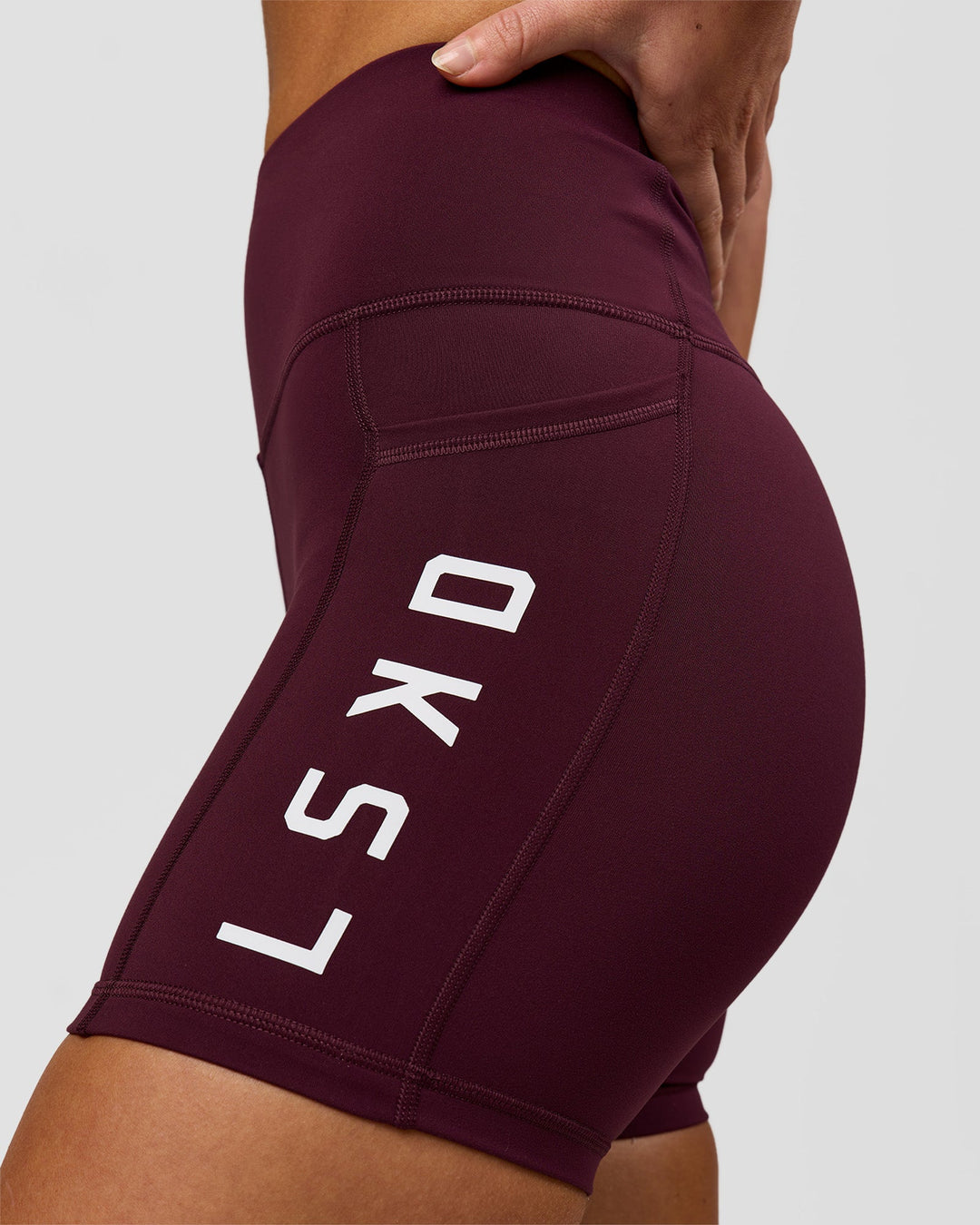 Woman wearing Rep Ultra High-Rise 4" Short Pockets - Cherry Lacquer-White | Model:Issy | Size:XS - view 5