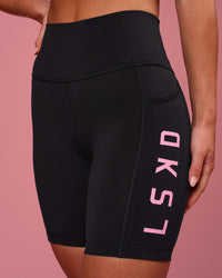 Woman wearing Rep Ultra High-Rise 6" Short Pockets - Black-Pink Rose | Model:Issy | Size:XS | Thumbnail Index: 3
