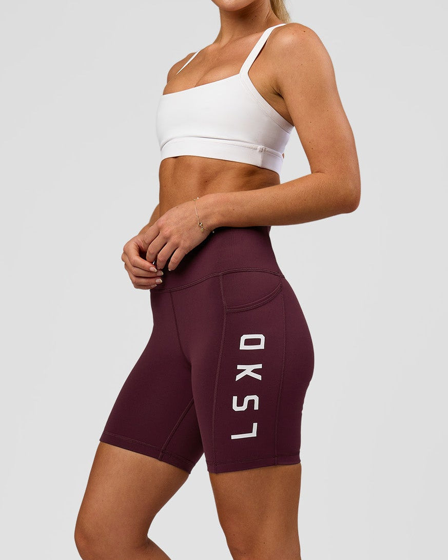Woman wearing Rep Ultra High-Rise 6" Short Pockets - Cherry Lacquer-White | Model:Issy | Size:XS
